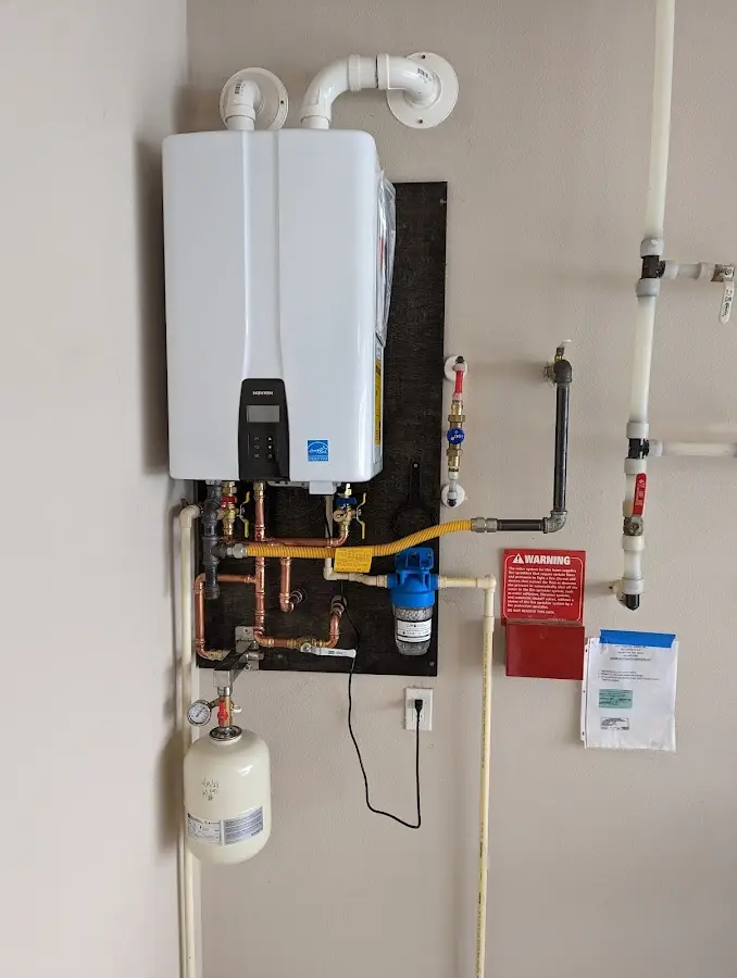 Professional plumber installing copper piping in a Bloomington home